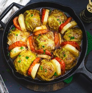 square photo of cabbage rolls in a skillet