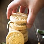 A hand grabbing a stack of shortbread cookies.