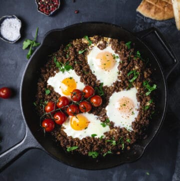 A pan of ground meat and eggs on a table