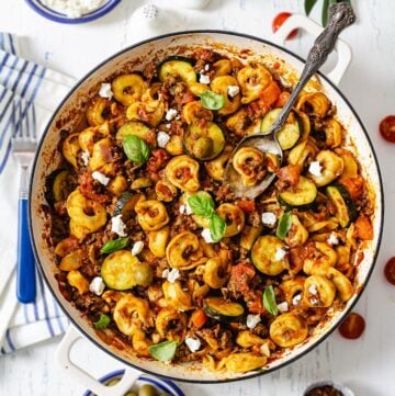 A bunch of food on a plate on a table, with Beef and Tortellini