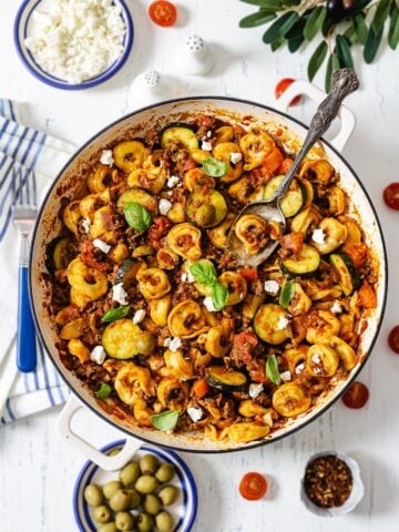 A bunch of food on a plate on a table, with Beef and Tortellini