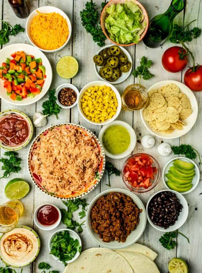 All ingredients and toppings for chipotle burrito bowl recipe placed in separate bowls