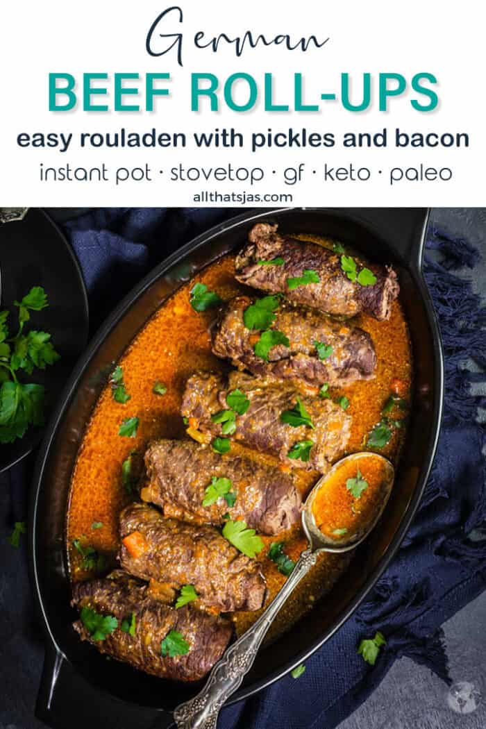 A flat lay of an oval black baking dish with beef rolls lined up in a sauce with text overlay