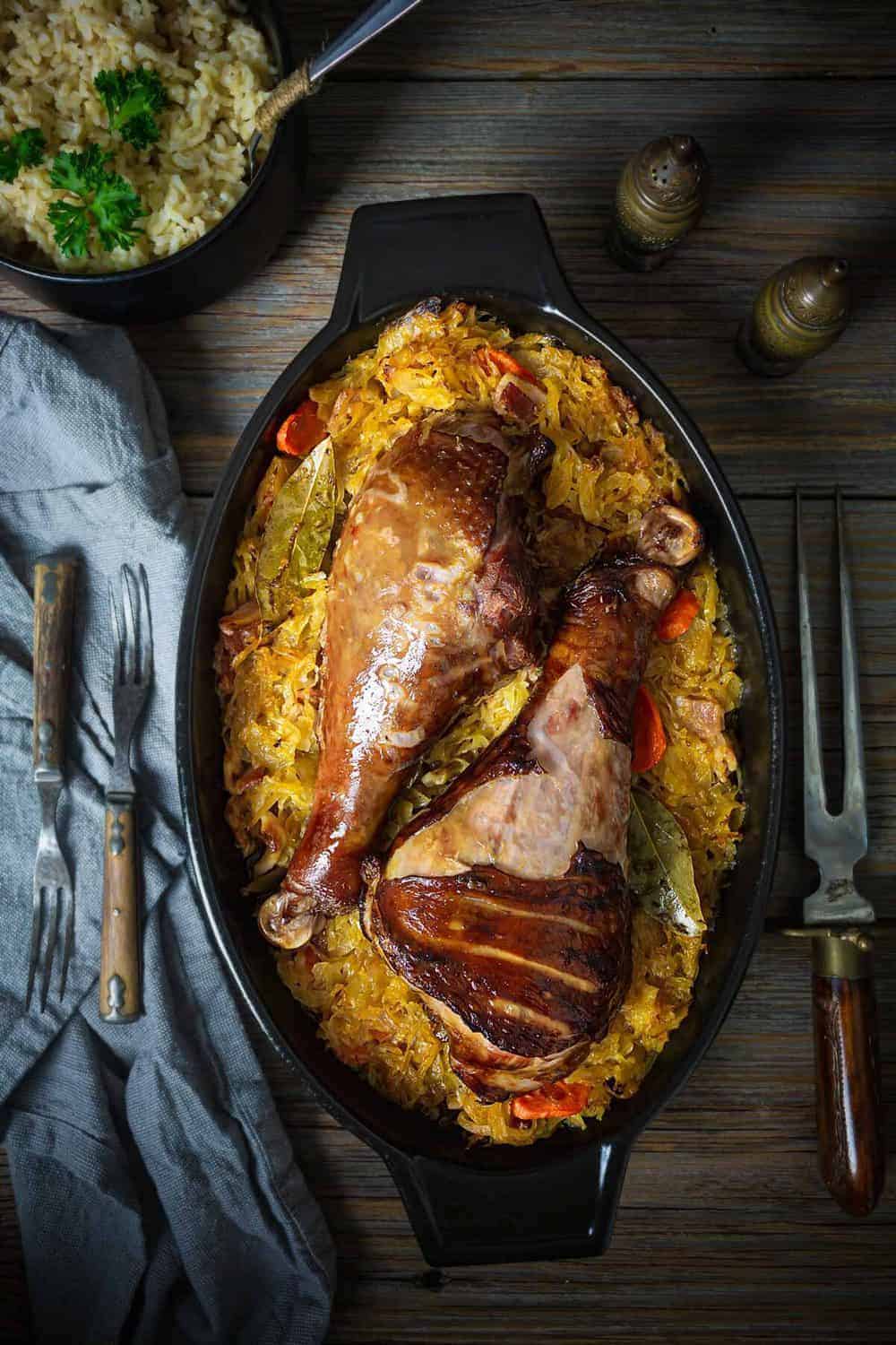 A baking dish with food sitting in a wooden table