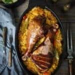 A baking dish with food sitting in a wooden table