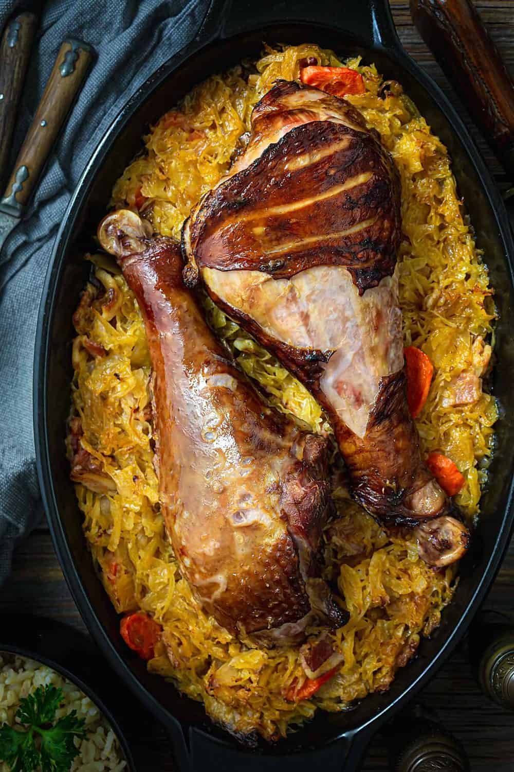 A close up of baked sauerkraut Serbian-style with turkey legs