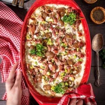 A person serving the dish with potato casserole