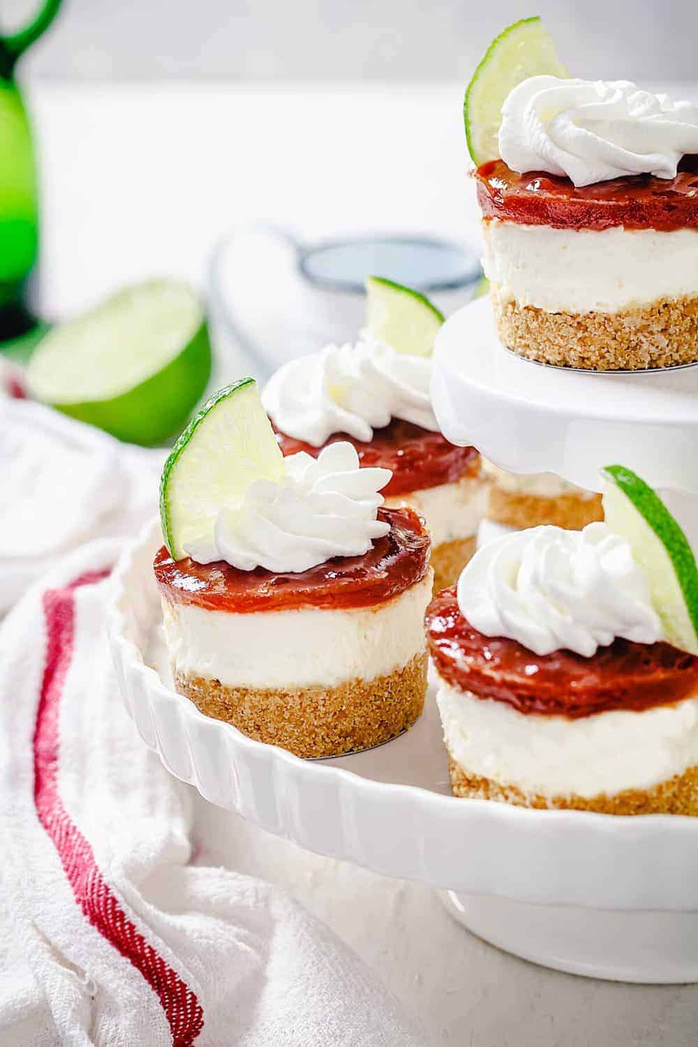 Close up of mini cheesecakes with lime and guava sauce