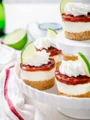 Close up of mini cheesecakes with lime and guava sauce
