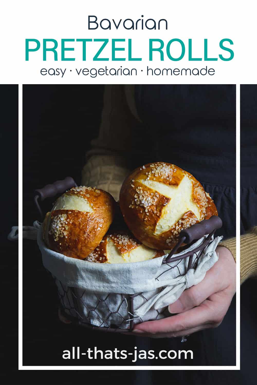 A person holding a basket with pretzel rolls and text overlay.