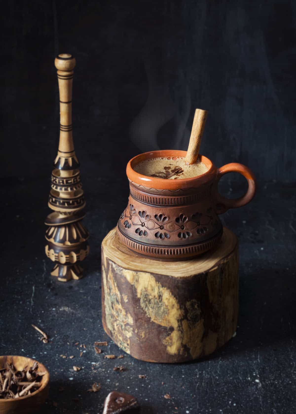 Hot chocolate - Oaxacan style in a clay mug with Molinillo, a traditional Mexican wooden whisk.