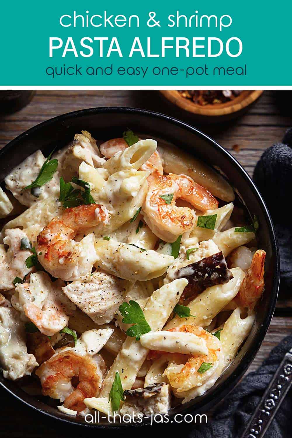 A close up pasta with chicken and shrimp scampi in a bowl with text overlay.