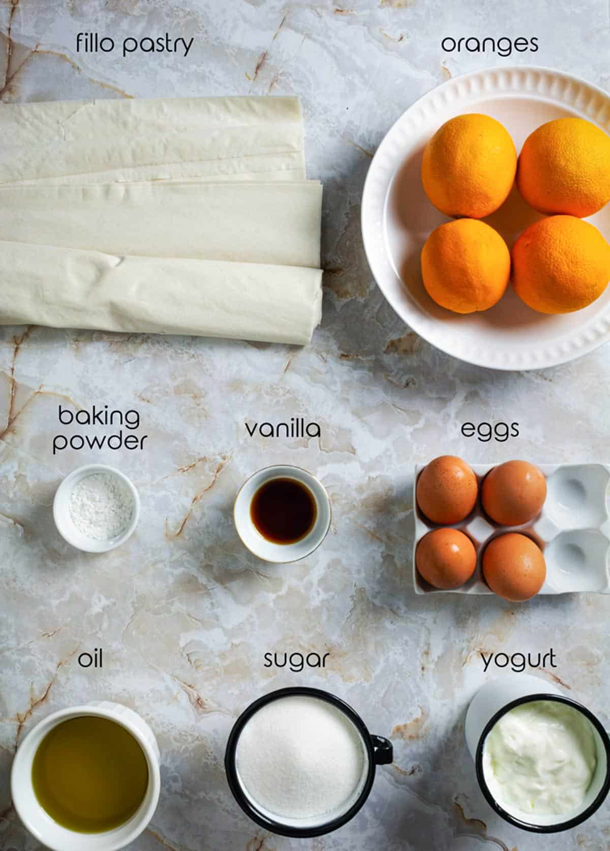 Ingredients for orange cake with phyllo on the table.