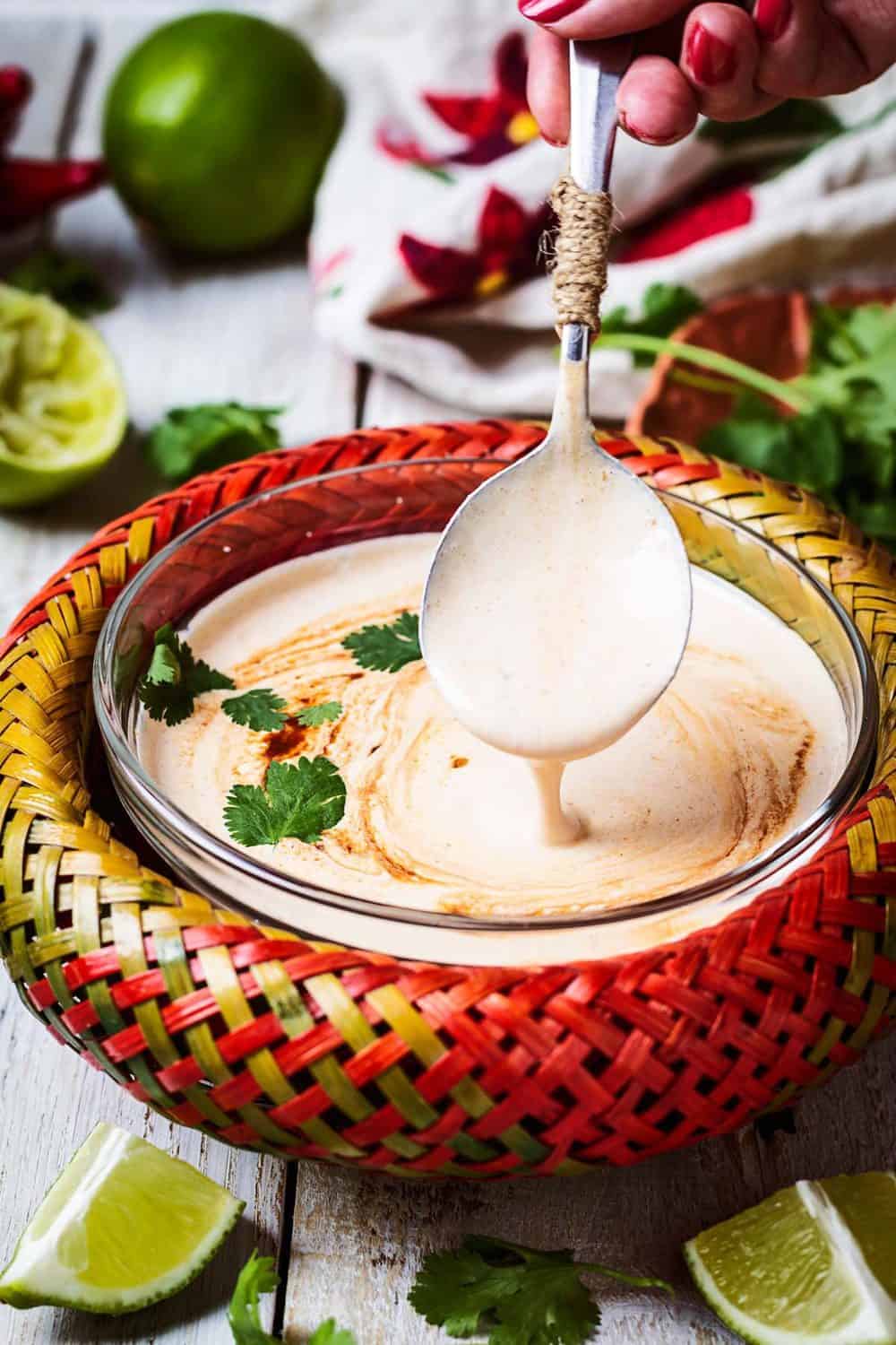 A close up of the sauce being scooped up with a spoon.