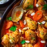 A close up of authentic African peanut soup with chicken and carrots.