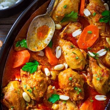 A close up of authentic African peanut soup with chicken and carrots.