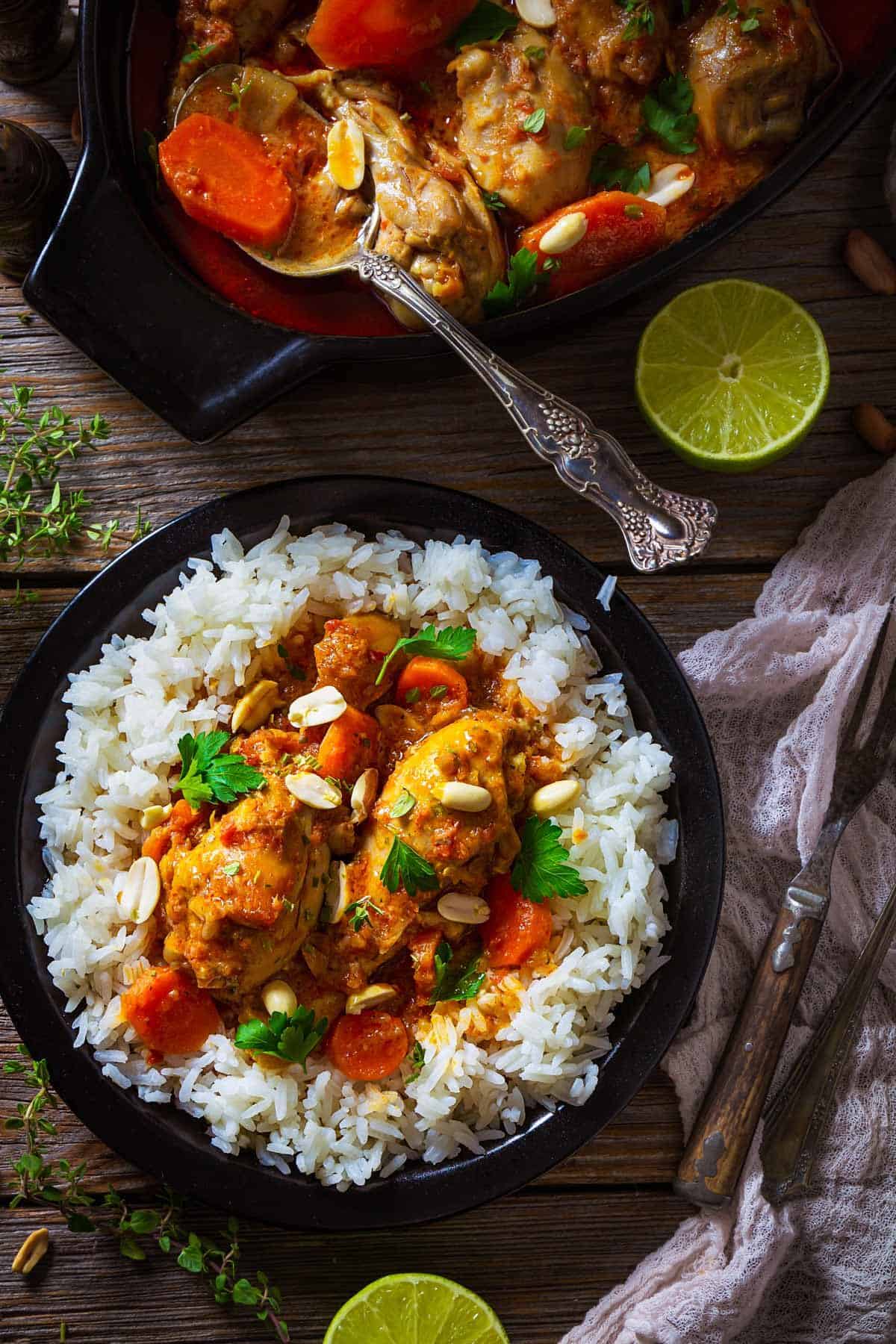 A plate with African spicy chicken peanut stew with peanuts and cilantro.