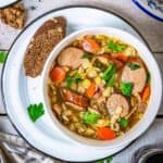 A bowl of German Graupensuppe in a bowl with barley and smoked sausage - featured square image
