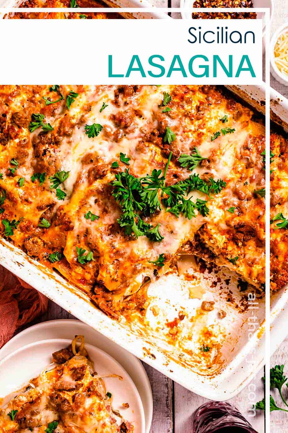 A pan of lasagna with one piece removed and text overlay.