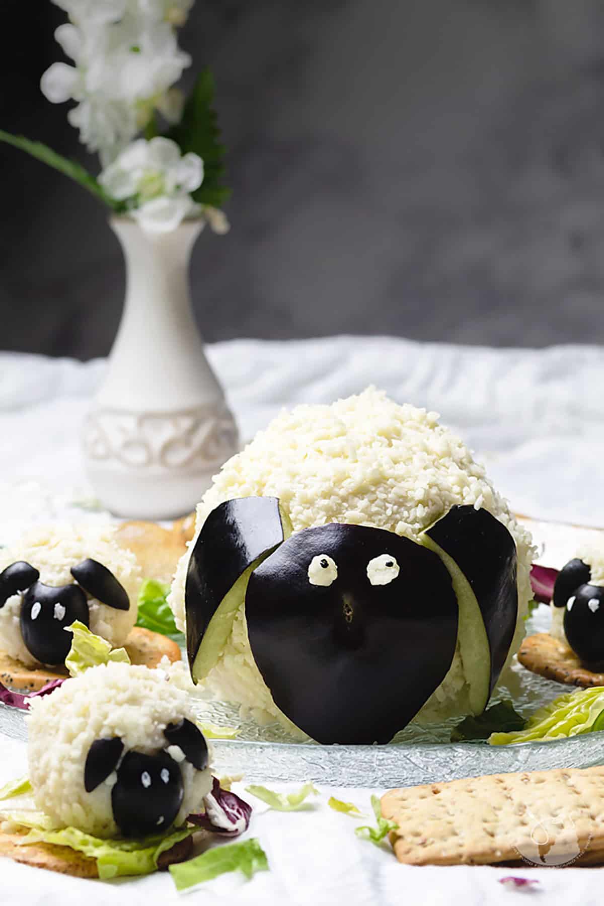 Cheese balls shaped like lamb and sheep on a table.