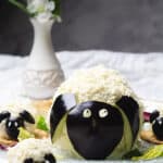 Cheese balls shaped like lamb and sheep on a table.