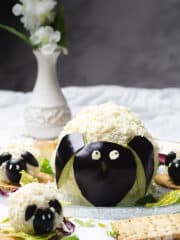 Cheese balls shaped like lamb and sheep on a table.