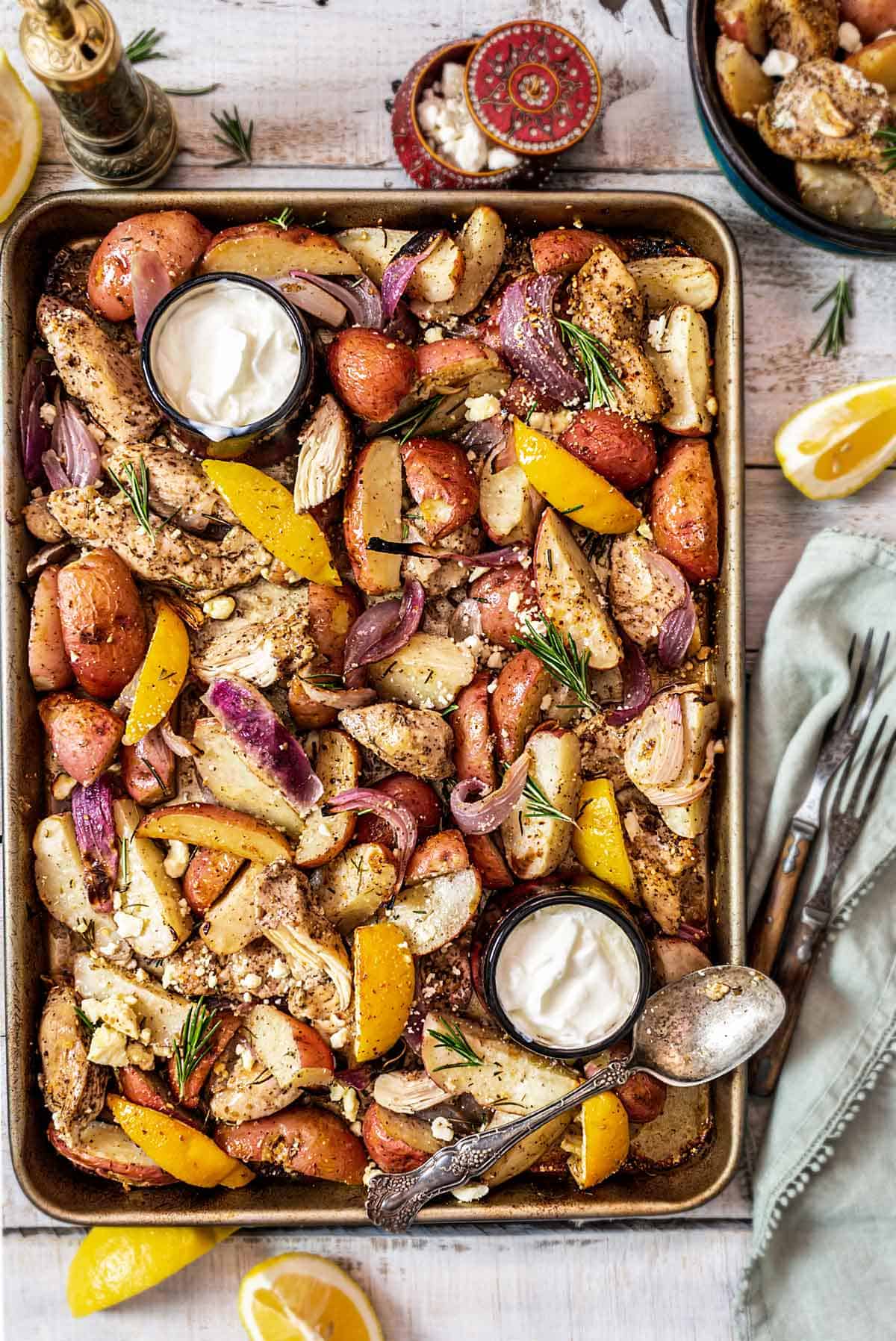 Mediterranean chicken and potato recipe with onions, feta, and tzatziki sauce.