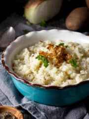 Vegan mashed potatoes in a bowl with caramelized onions - featured square image.