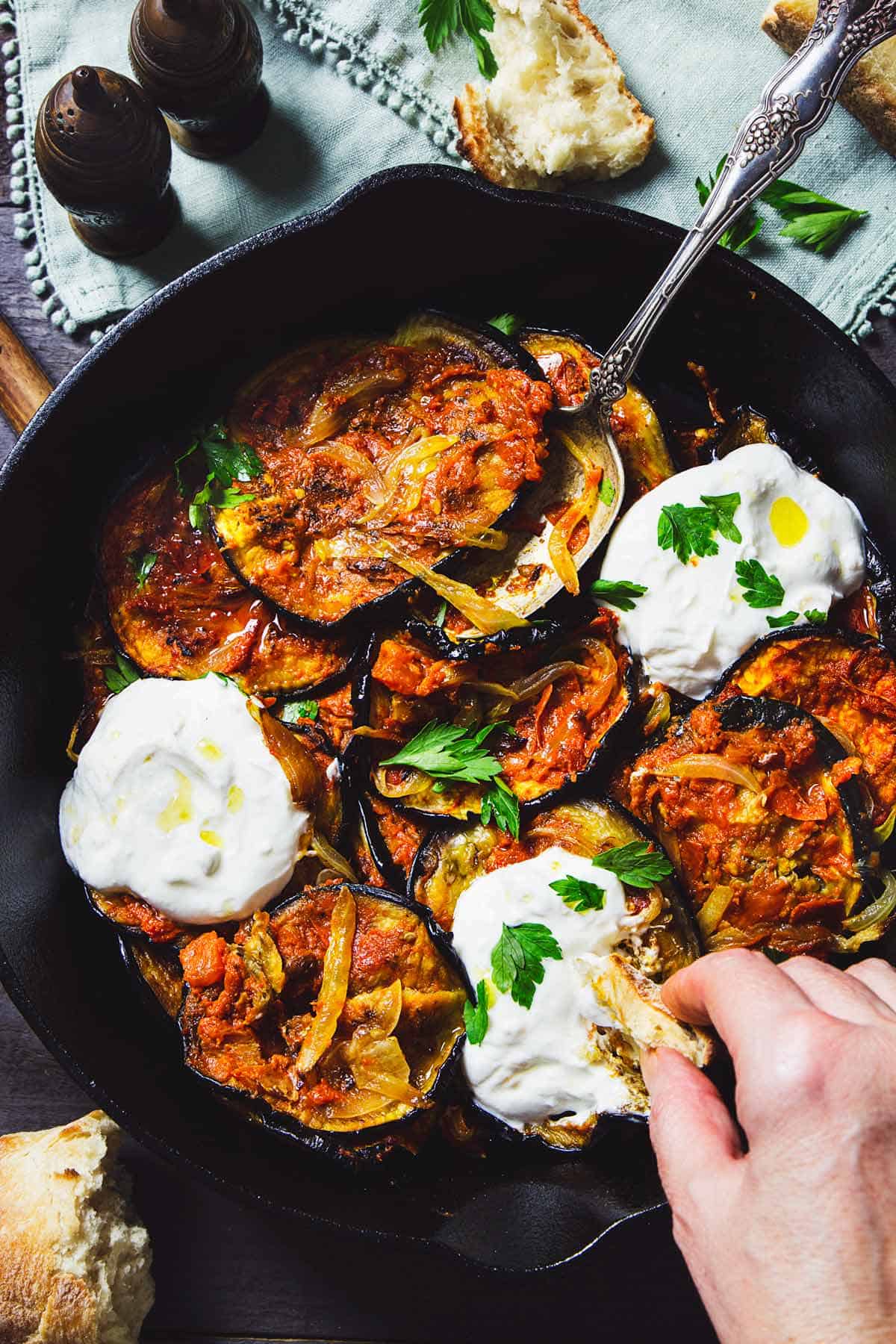 Dipping bread into roasted eggplant dish from Afghanistan. 