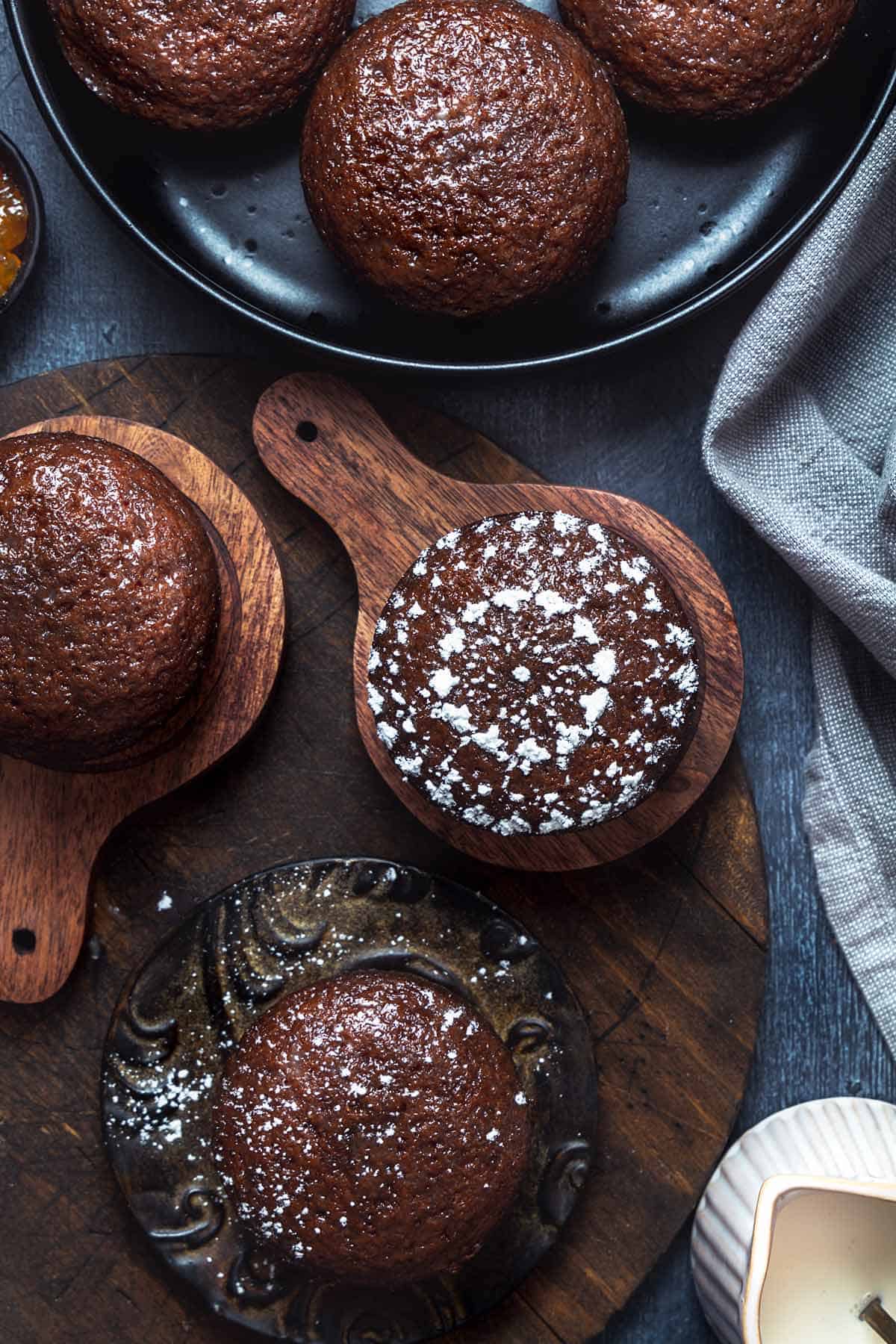 Overhead shot of Malva pudding cakes on the wooden boards.