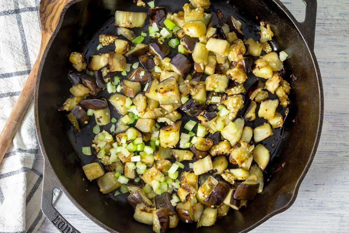 Roasted eggplant and celery in a pan.
