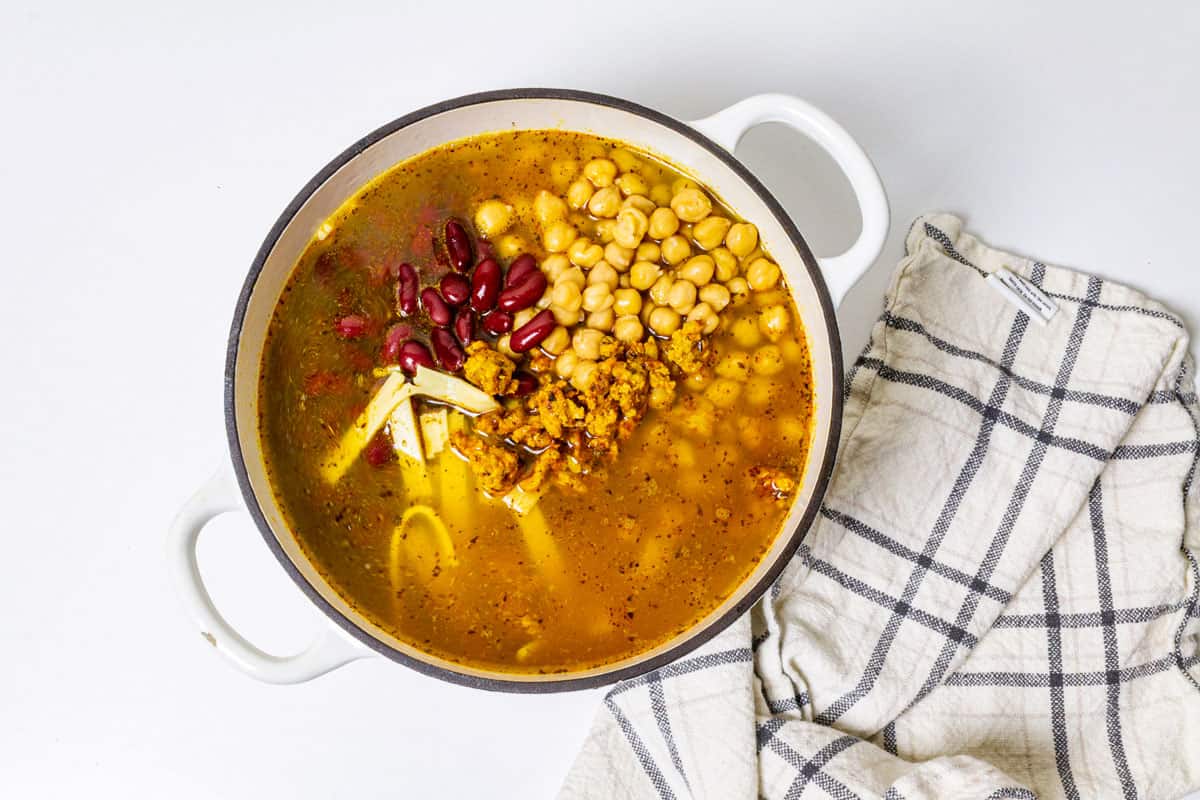 Kidney beans, cooked chicken, and garbanzo beans, added to the pot with noodles.