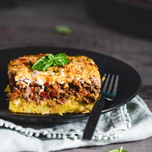 A serving of polenta casserole showcasing its layers.