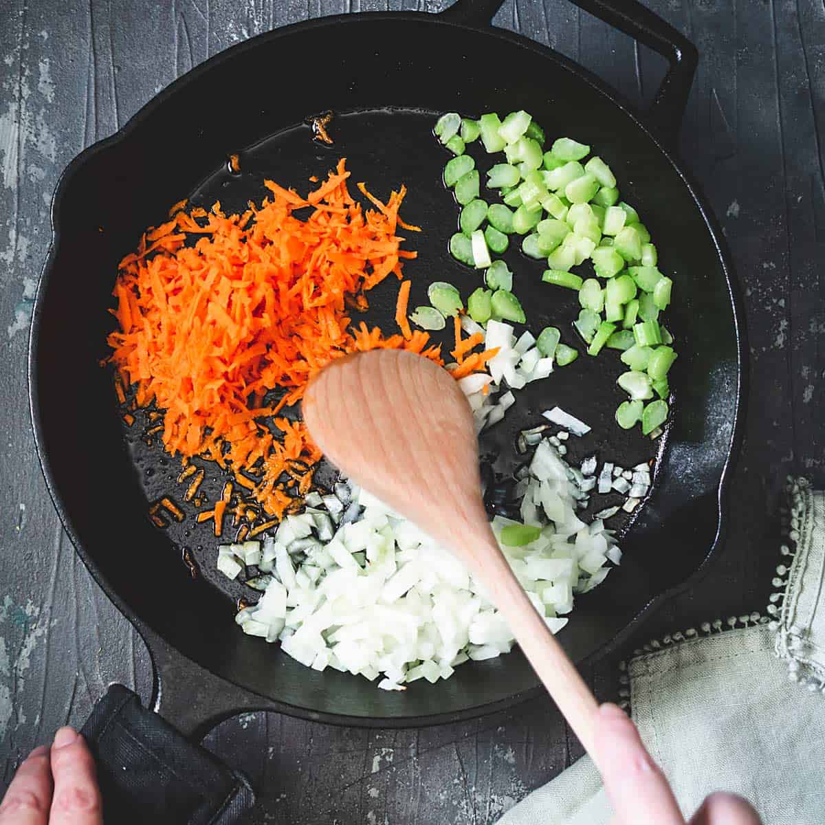 Cooking vegetables in a cast-iron skillet.