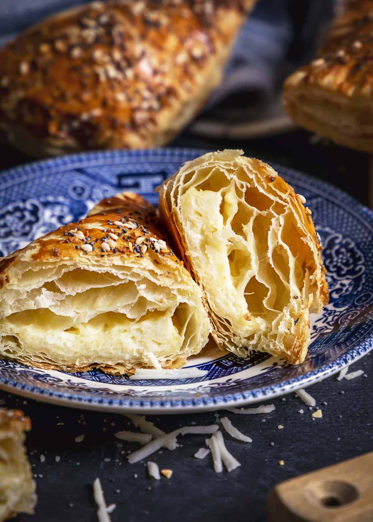 Sliced cheese borekas showing the filling and puff pastry flaky layers. 