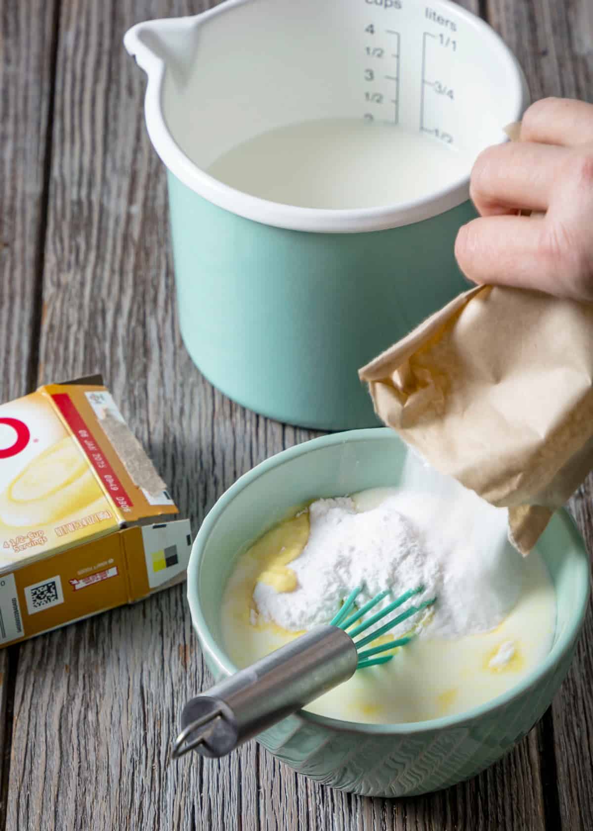 Mixing instant pudding with milk.