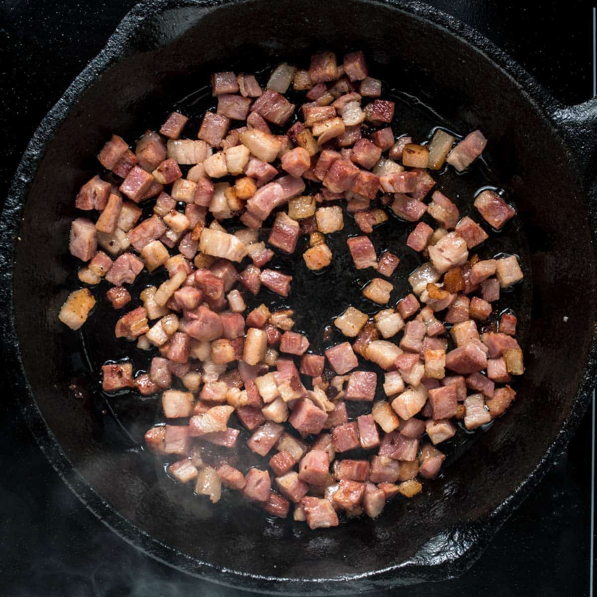 Cooking the bacon for haluski in a skillet.