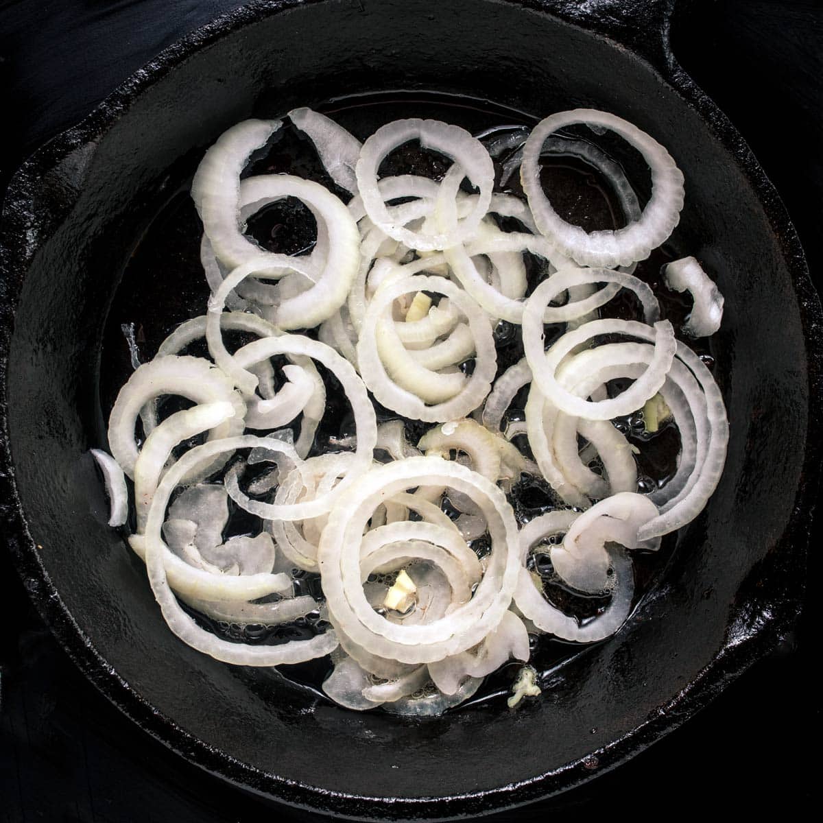 Sautéing the onions in a skillet to make haluski.