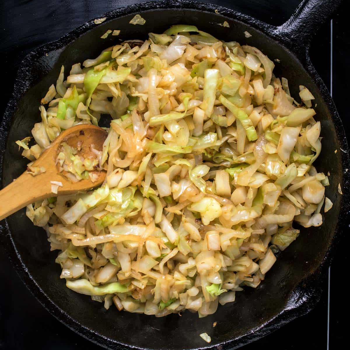 Frying the cabbage for haluski in a cast-iron skillet.