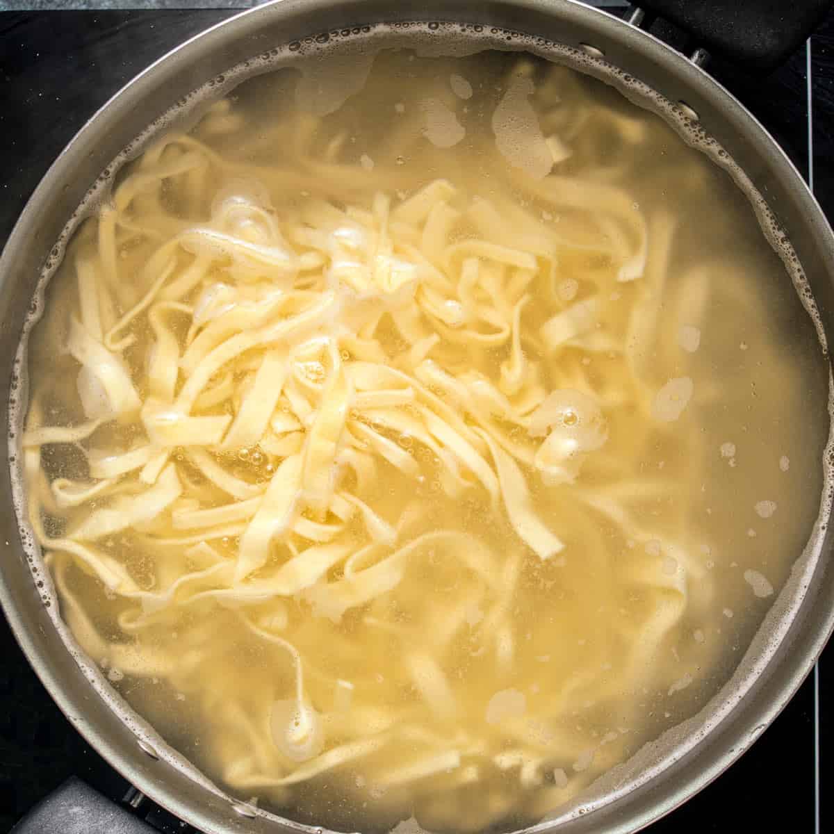 Cooking noodles for fried cabbage and noodles recipe.