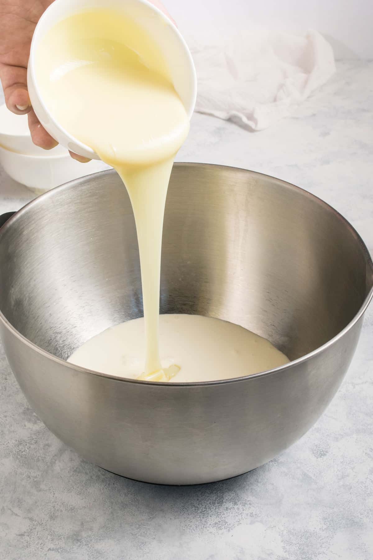 Adding all ingredients for margarita ice cream in a large bowl.