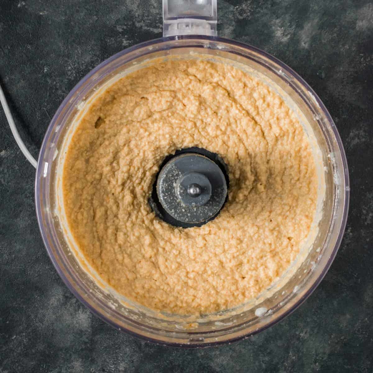Creamy homemade garlic hummus made in a food processor.
