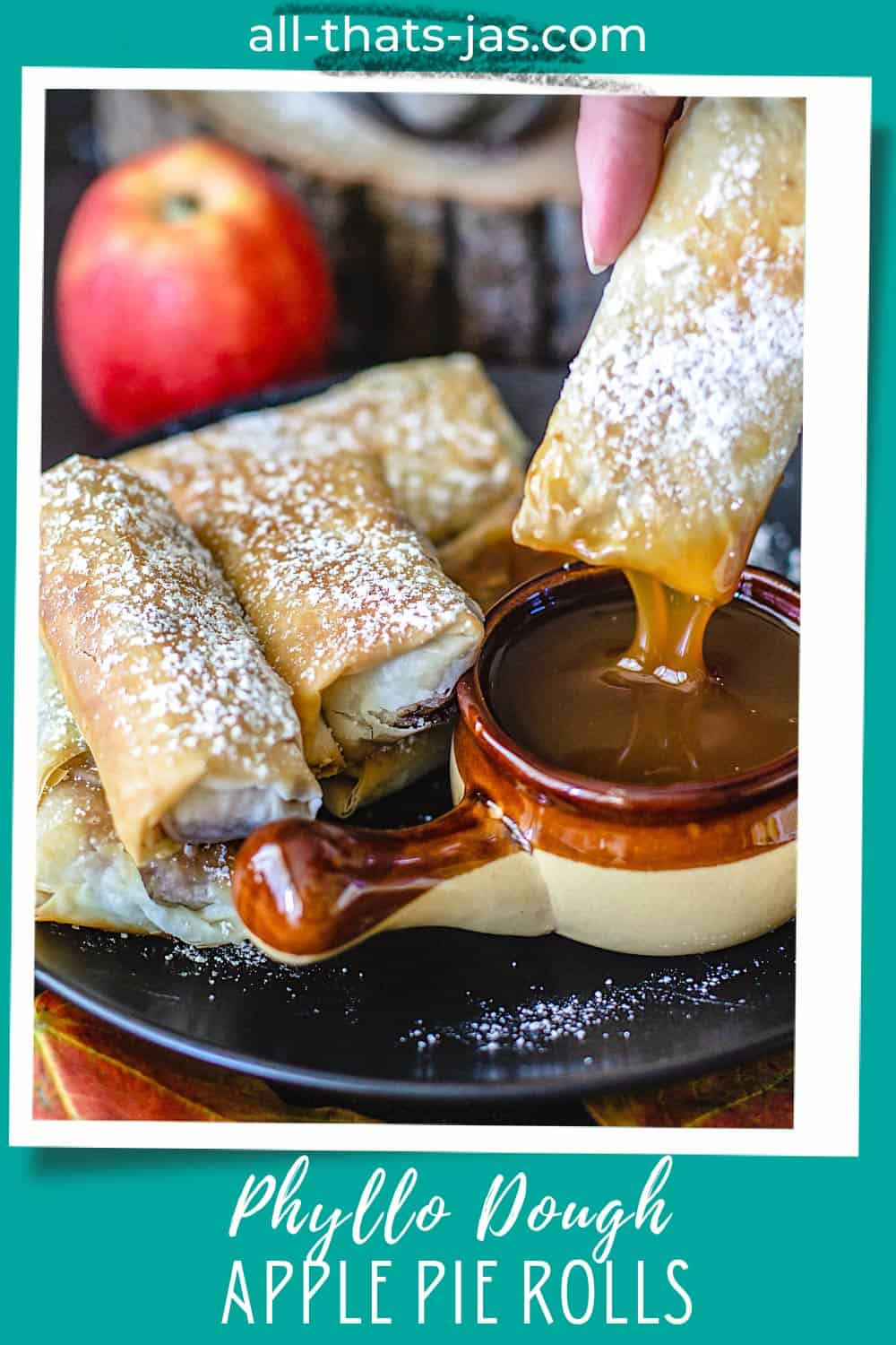 Dipping apple pie spring rolls into caramel sauce with text overlay.