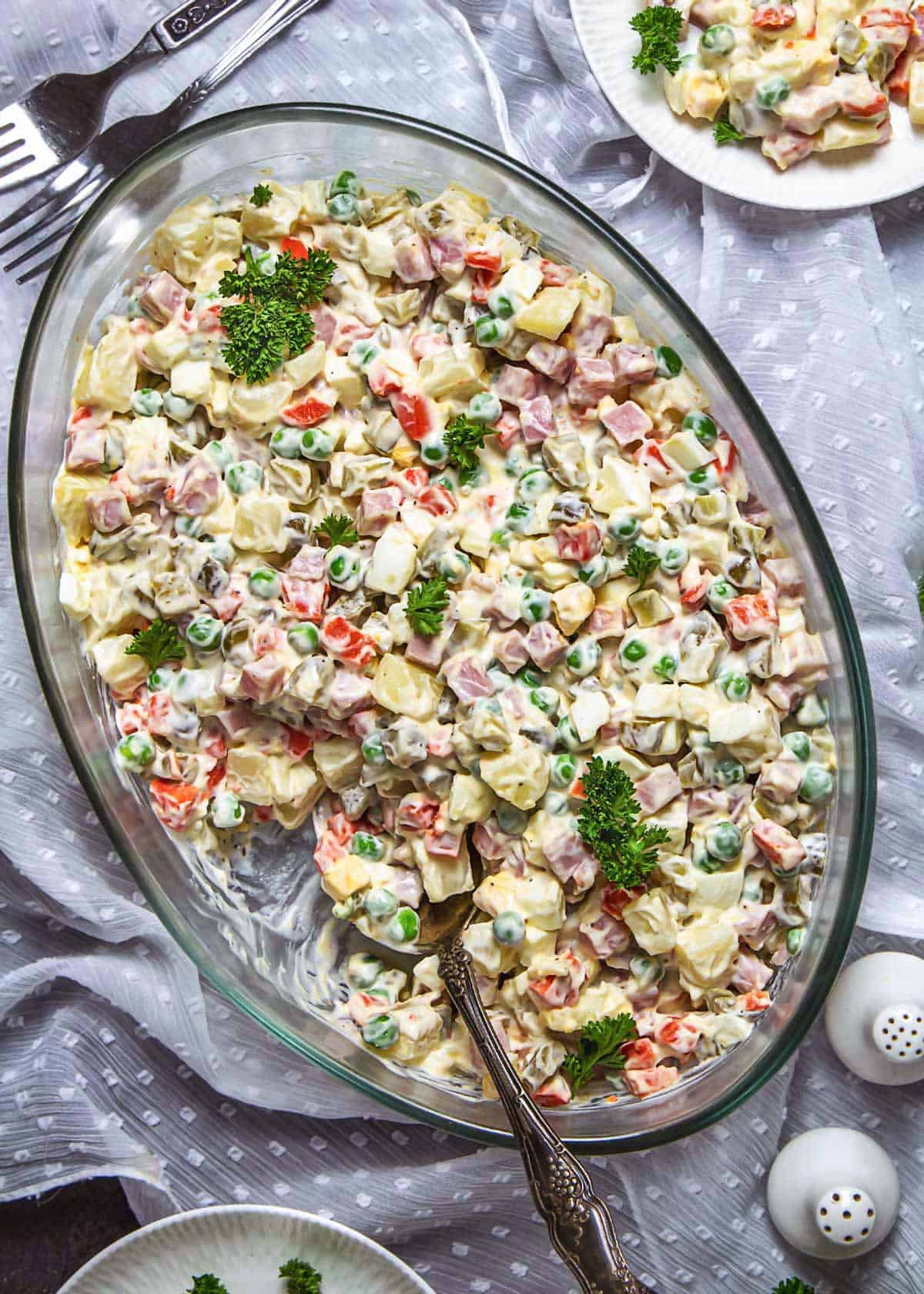 Russian potato salad in an oval glass dish.
