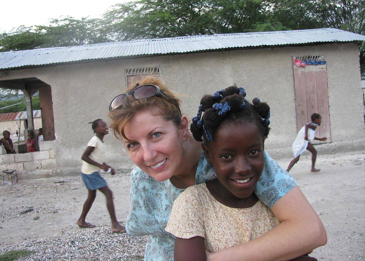 Jas in Haiti with a local girl.